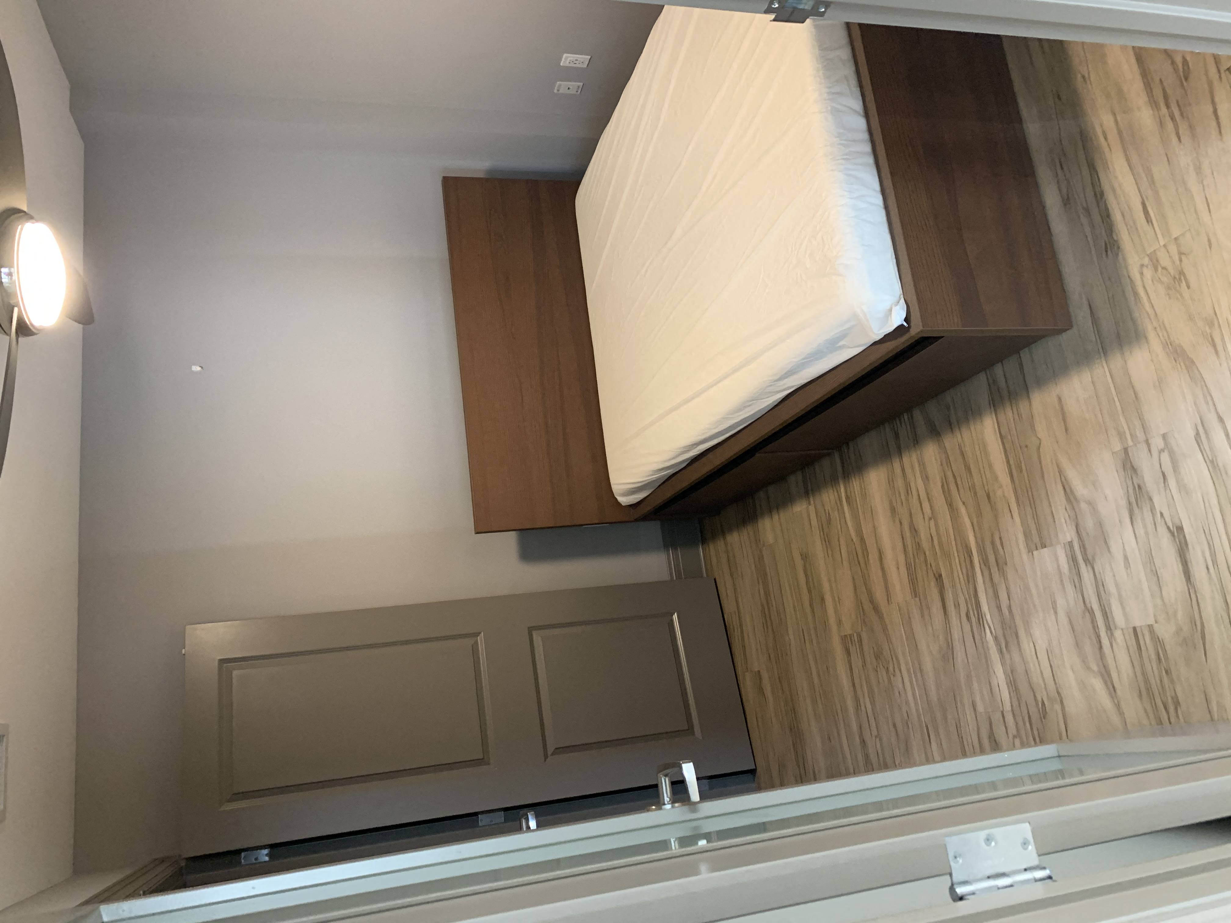 a window in a bathroom with a wooden wall and a mirror