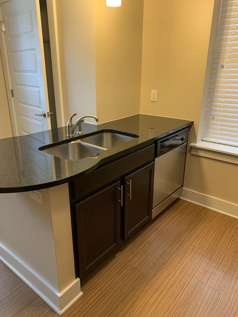 an empty kitchen with a sink and a window