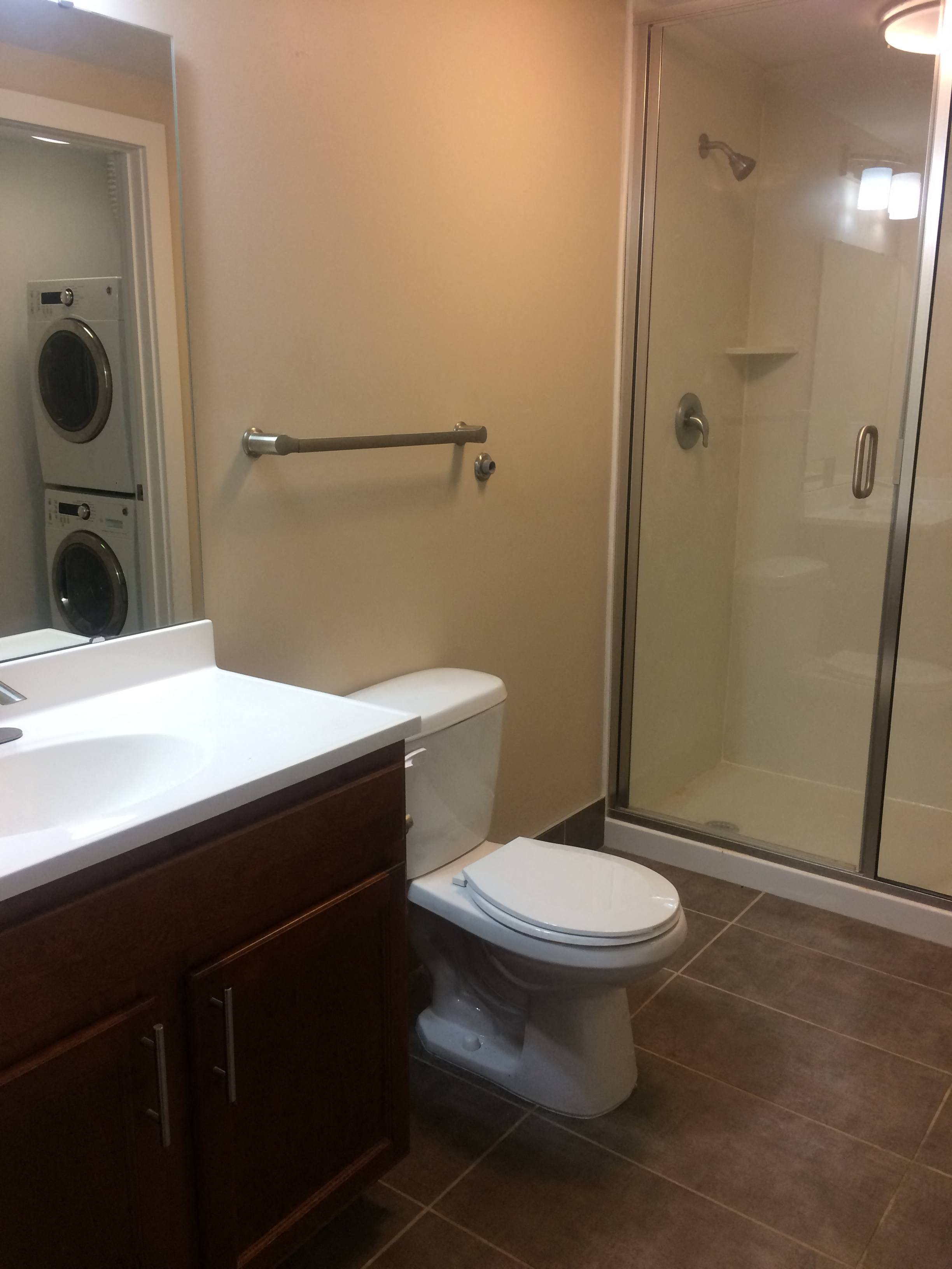 a bathroom with a toilet and a shower and a sink