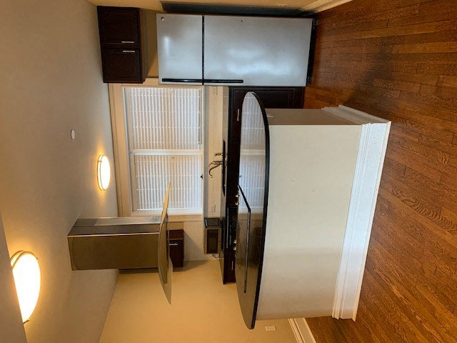 a kitchen with a refrigerator and a mirror
