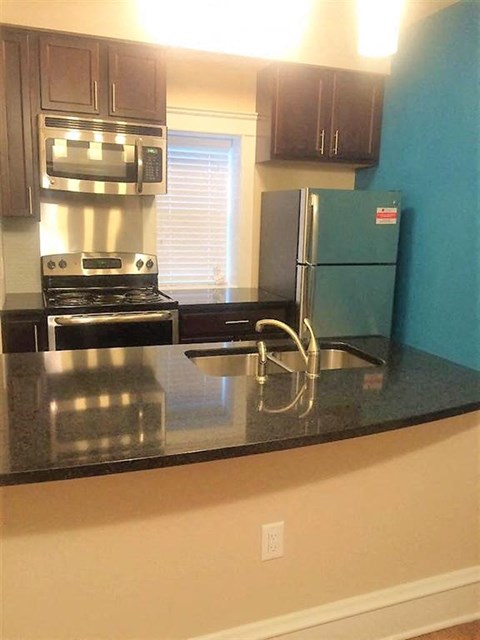 a kitchen with a stove and a refrigerator
