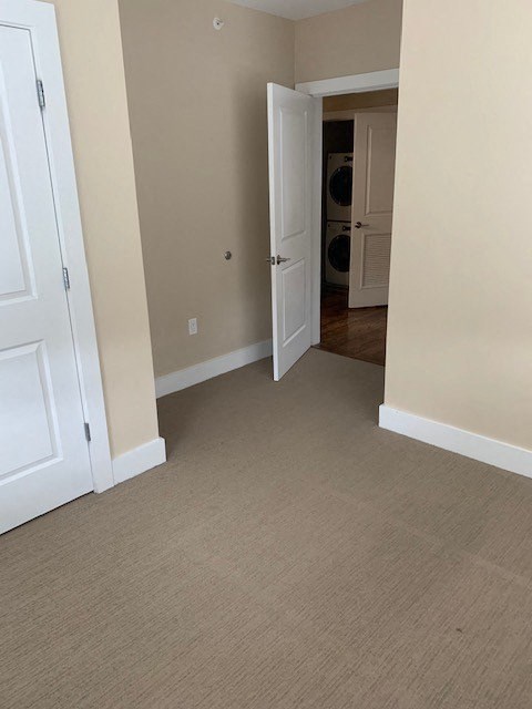 an empty room with a door open to a hallway