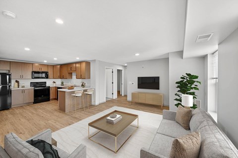 A modern living room with a grey sofa and a coffee table.