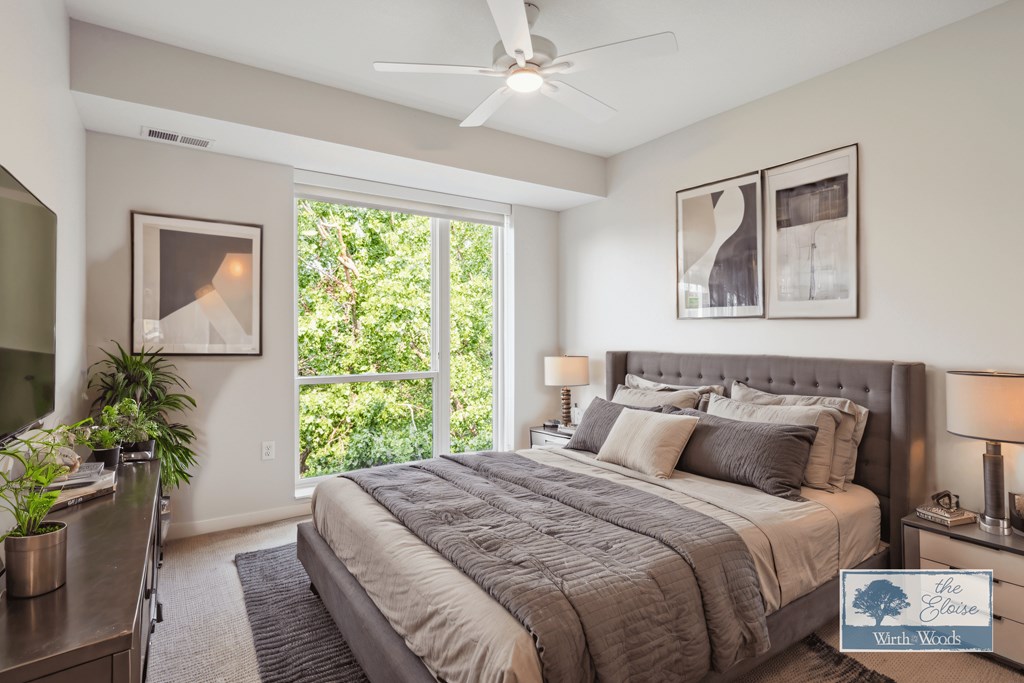 a bedroom with a large bed and a ceiling fan