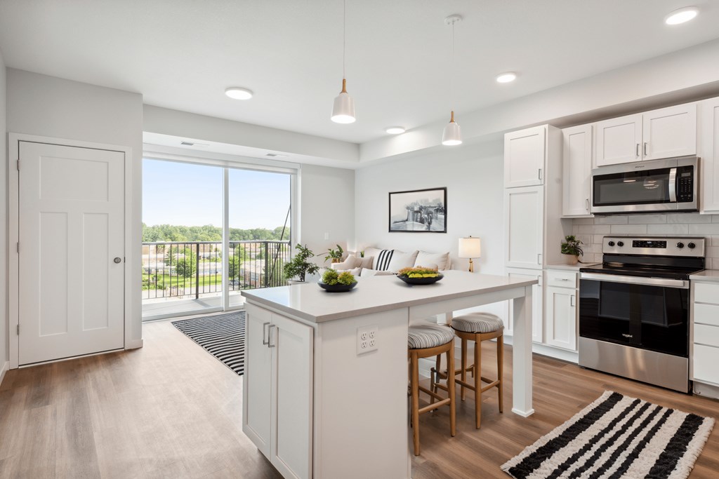 an open kitchen with a large island with two stools