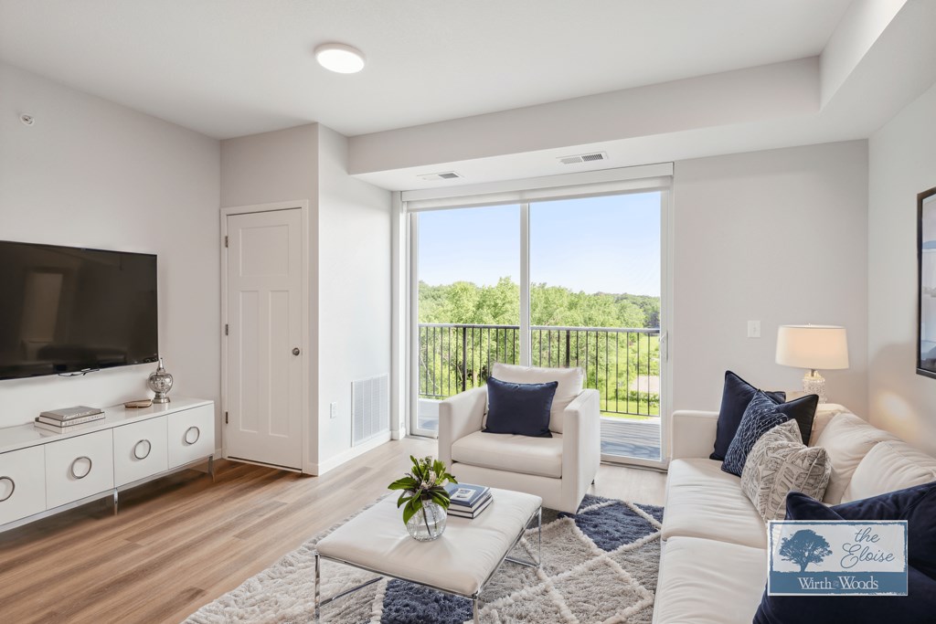 a living room with a couch and a chair and a television