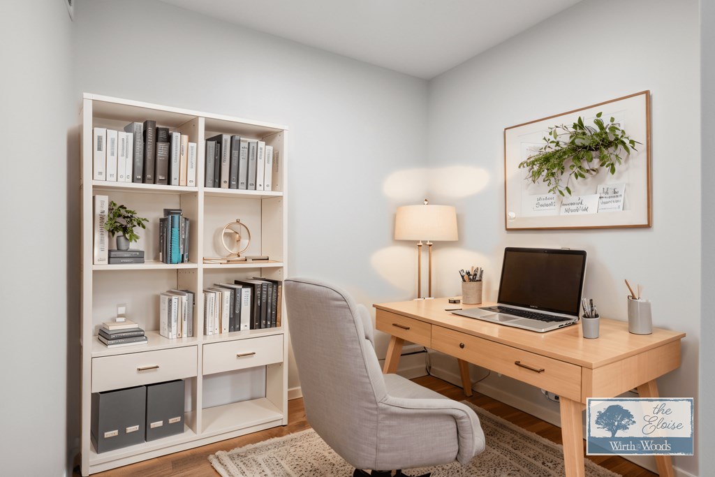 a home office with a computer desk and a bookshelf