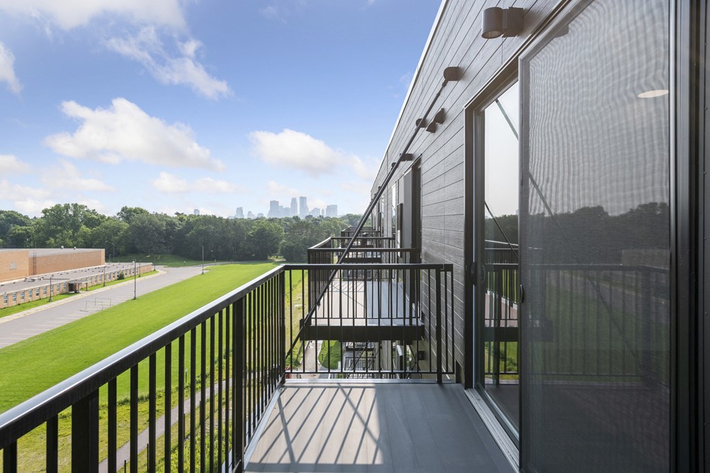 a balcony with a view of the city in the distance