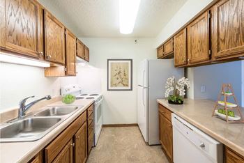A kitchen with wooden cabinets and a white refrigerator.