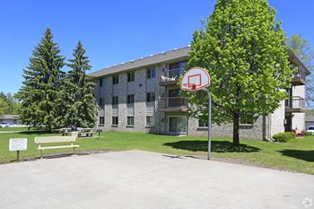 A basketball hoop is in front of a building.