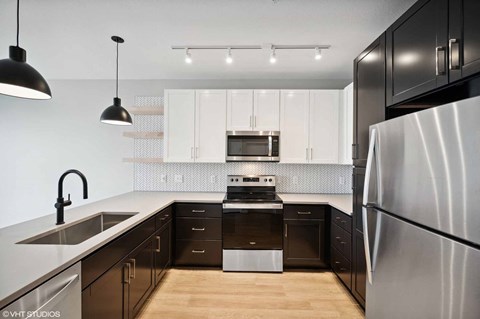 a modern kitchen with white cabinets and stainless steel appliances