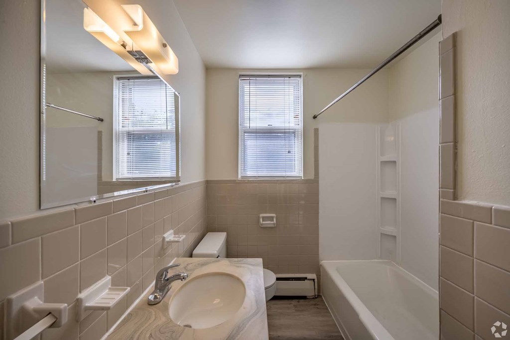 A bathroom with a sink, toilet, and bathtub.