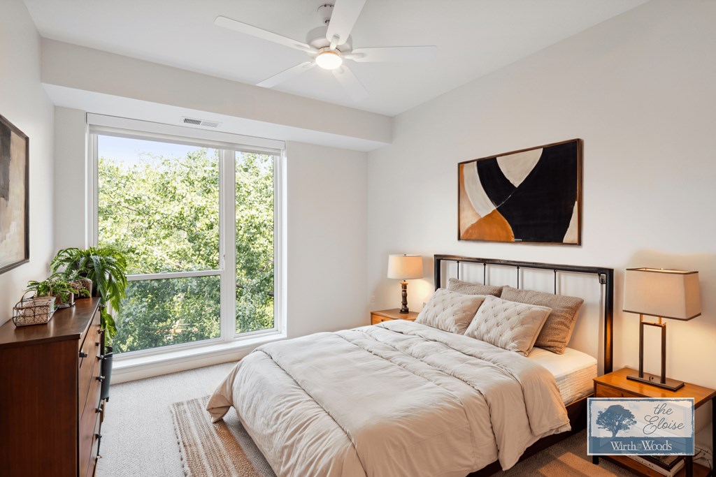 a bedroom with a bed and a ceiling fan