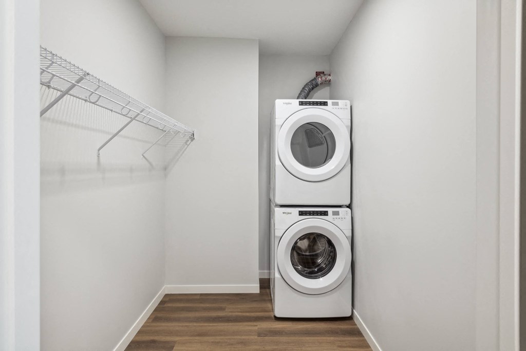 a white washer and dryer in a laundry room with a white closet