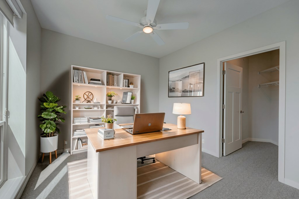 a home office with a desk and a laptop computer