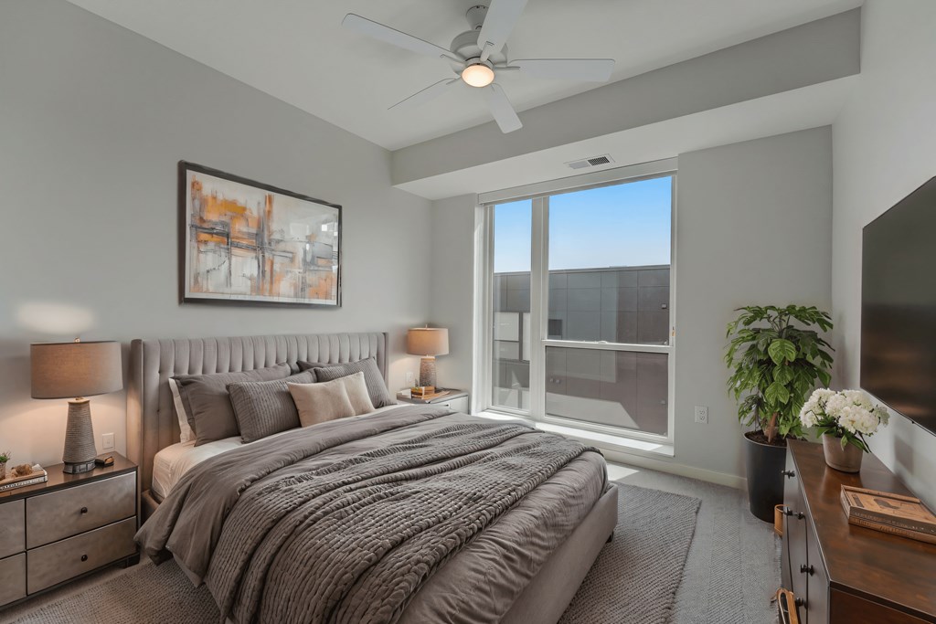 a bedroom with a large bed and a large window
