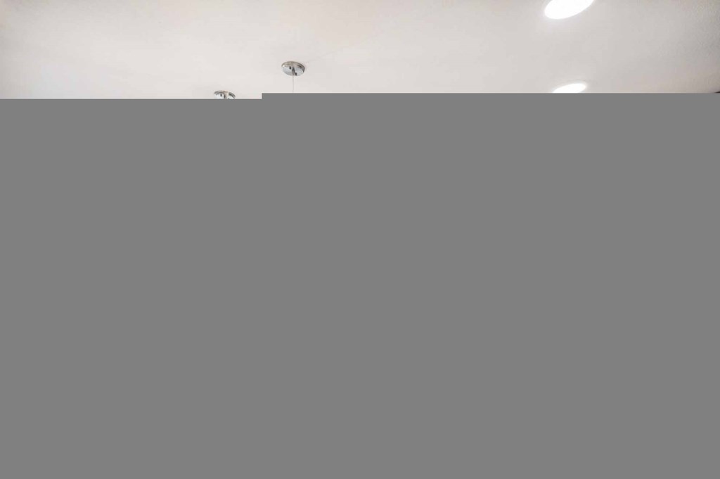 a kitchen with wooden cabinets and stainless steel appliances