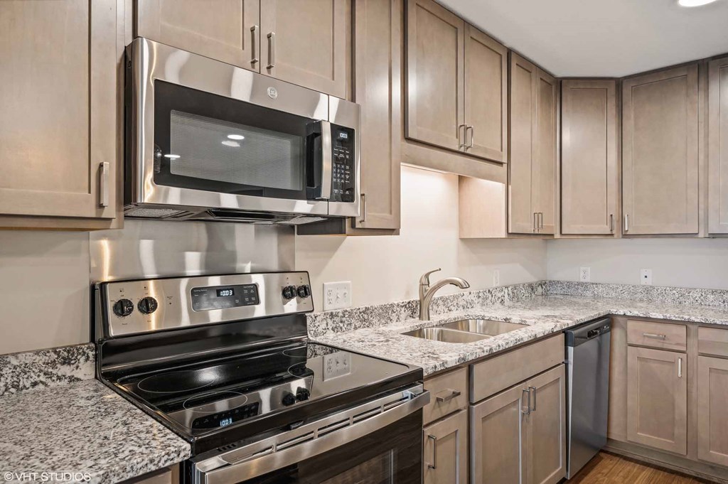 a kitchen with stainless steel appliances and granite counter tops