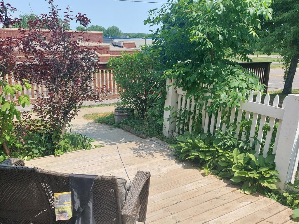 a deck with a white picket fence