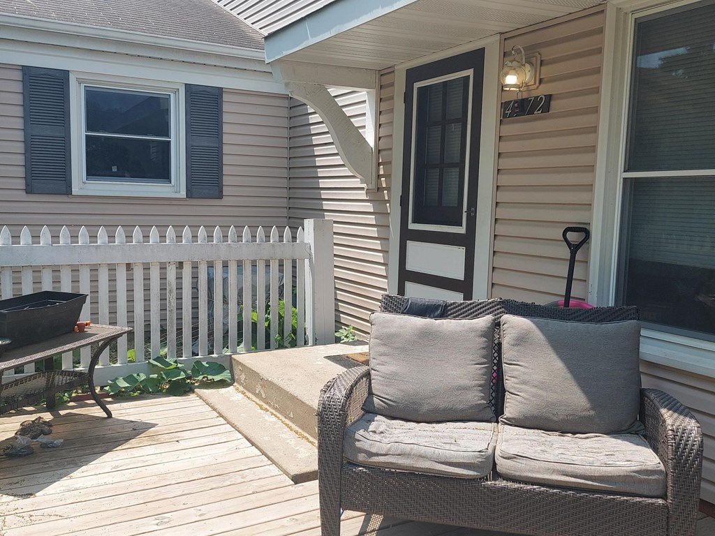 a deck with a couch and a table