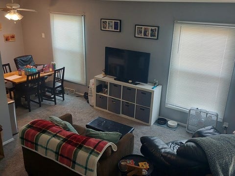 a living room and dining room with a couch and a tv
