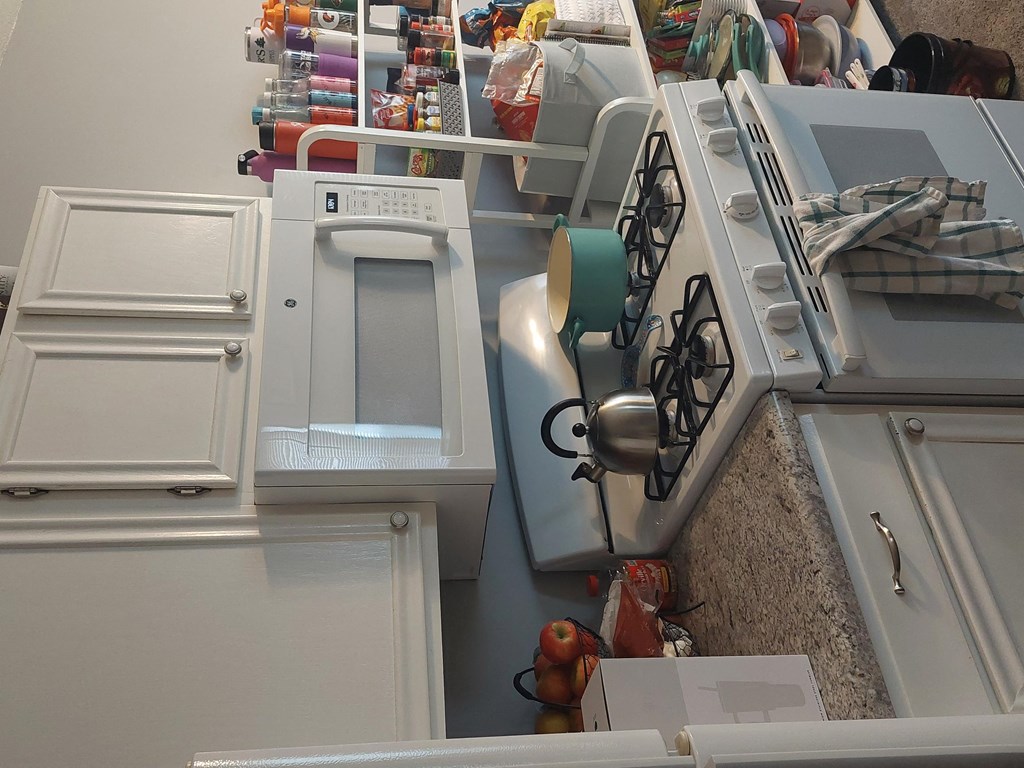 an overhead view of a laundry room with several washer and dryers and a washing machine