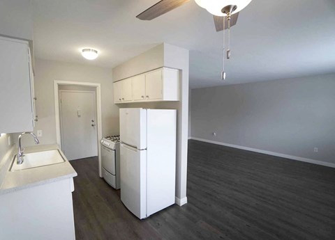 a kitchen with a refrigerator and a stove and a sink