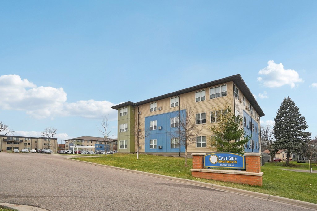 A building with a sign that says East Side in front of it.