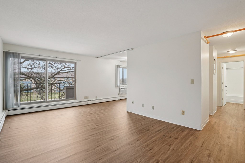 A room with wooden floors and white walls.
