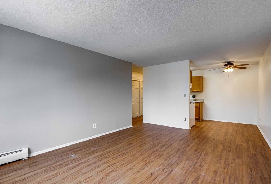 A room with wooden floors and white walls.
