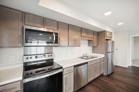 a kitchen with stainless steel appliances and wooden cabinets