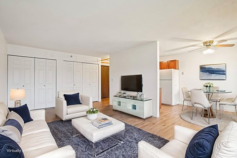 A living room with white furniture and a flat screen TV.