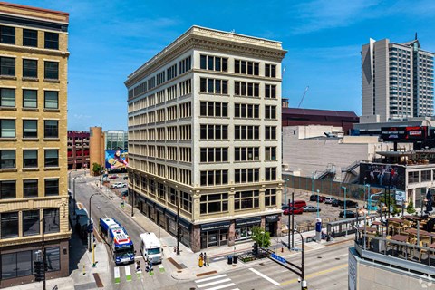 A city street with a large building in the middle.