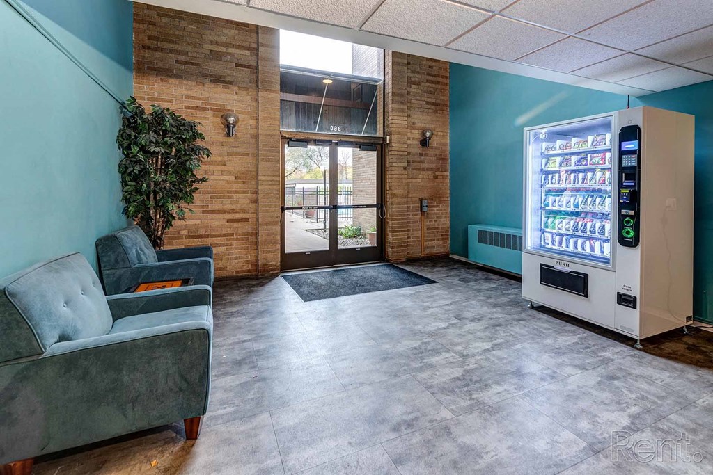 a lobby with a couch and a vending machine
