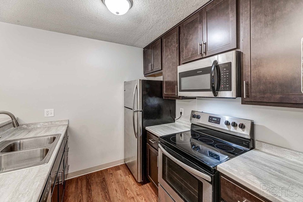 a kitchen with stainless steel appliances and wooden cabinets