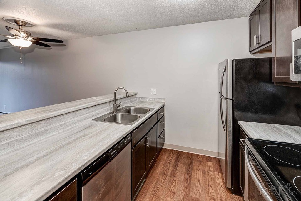 a kitchen with a sink and a refrigerator