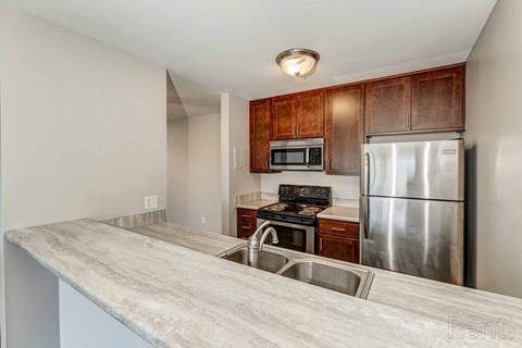 a kitchen with stainless steel appliances and a counter top