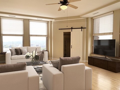 a living room with white furniture and a tv