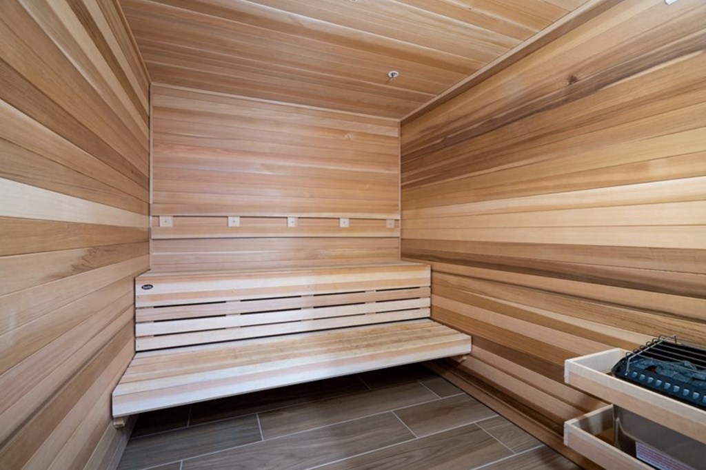 a sauna in a home gym with wooden walls and benches