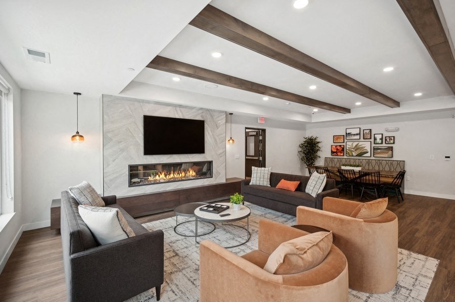 a living room with couches and chairs and a fireplace