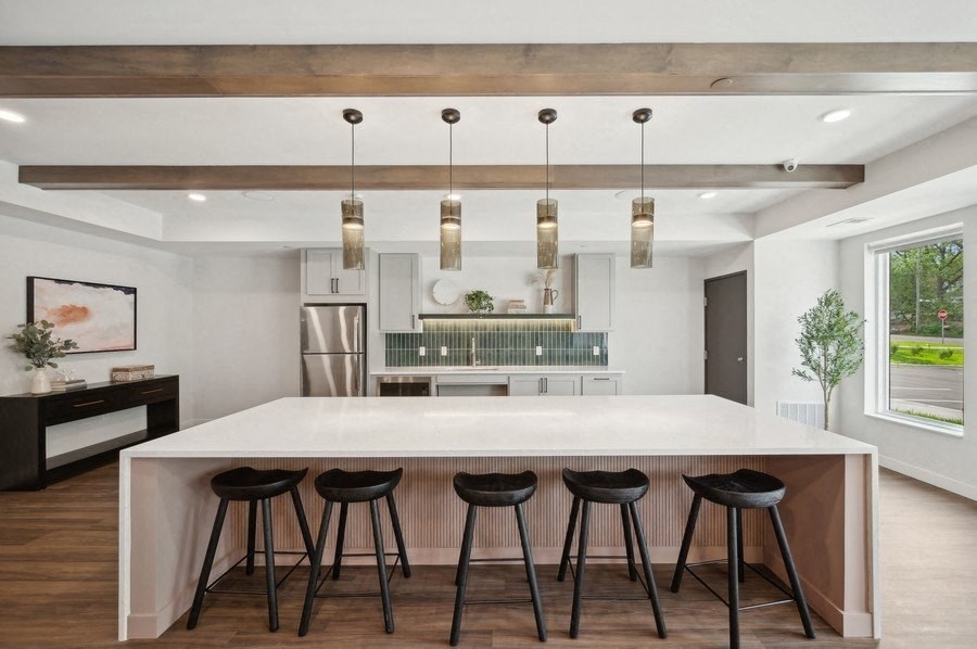 a kitchen with a large island and four bar stools
