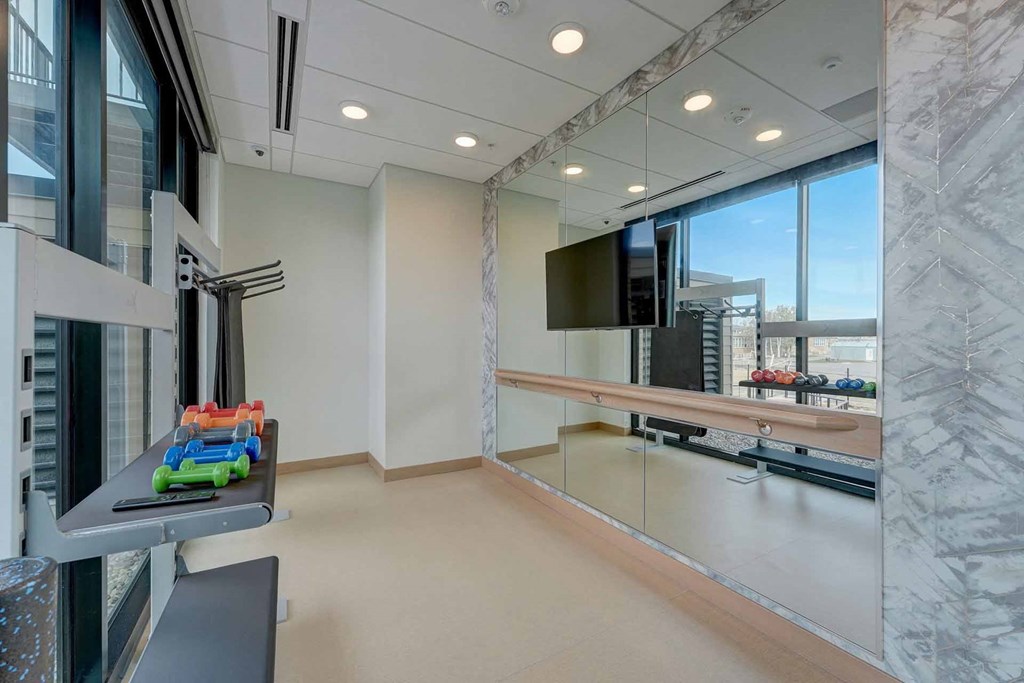 a room with a television and a table with a childs toy