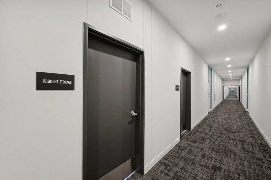 a corridor of elevators and doors in an office building