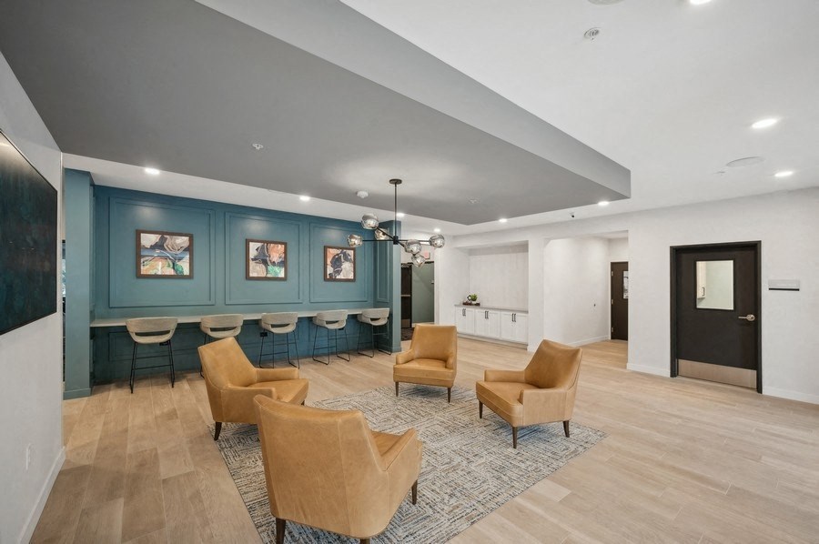 the lobbies with chairs and a bar in the lobby of a building