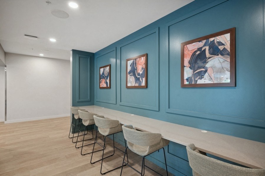 the tasting room is decorated with blue walls and a long counter with chairs