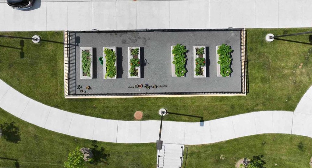 an aerial view of a parking lot with grass and trees