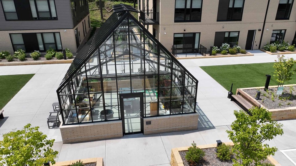 an aerial view of a greenhouse on the side of a building