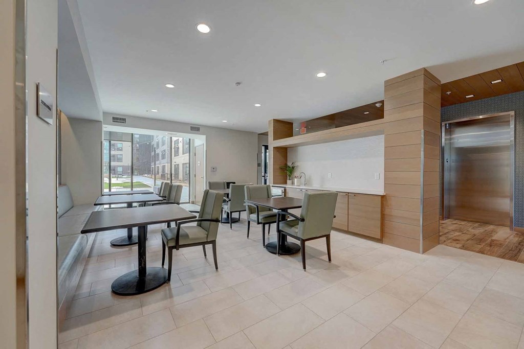 a dining room with tables and chairs and a counter