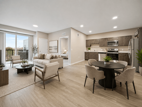 A modern living room with a dining table and chairs.