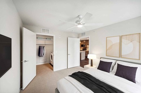a bedroom with a bed and a ceiling fan